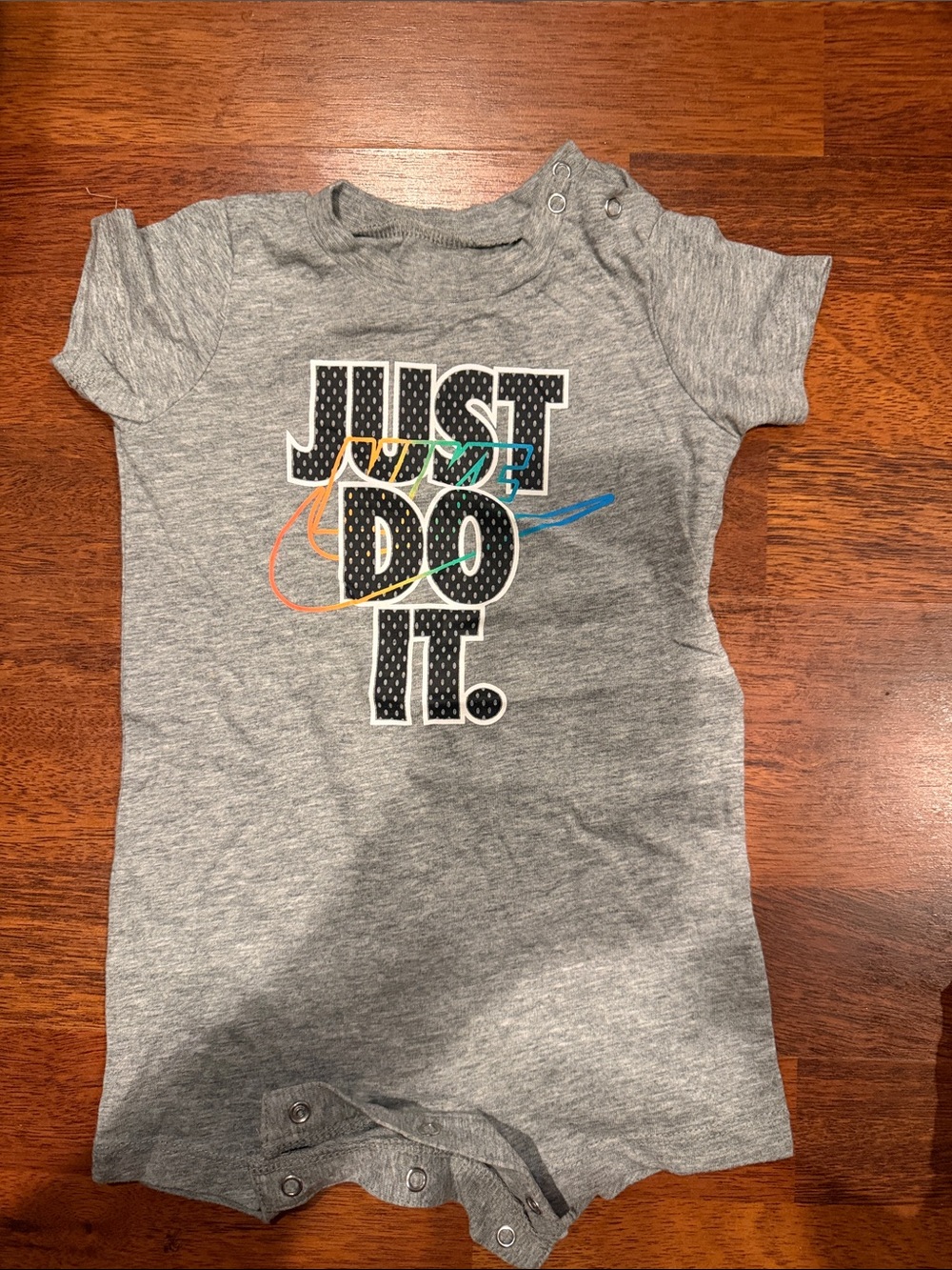 Nike Gray 'Just Do It.' Baby Romper with Multicolor Accent